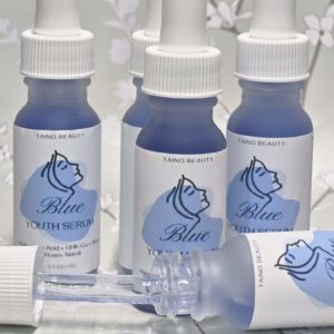 A group of five blue glass bottles with white dropper caps, labeled Blue Youth Serum