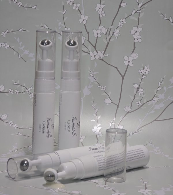 Immortelle Eye Serum in sleek white packaging, designed to reduce fine lines, puffiness, and dark circles, offering a natural anti-aging solution for the delicate eye area.